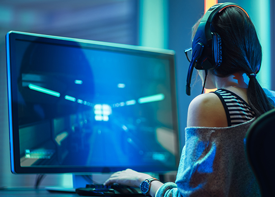 Mujer jugadora de videojuegos sentada y jugando a un videojuego